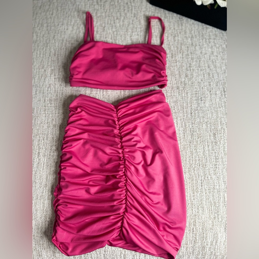 Hot pink- size s/m with adjustable straps for the top.
Mini skirt.